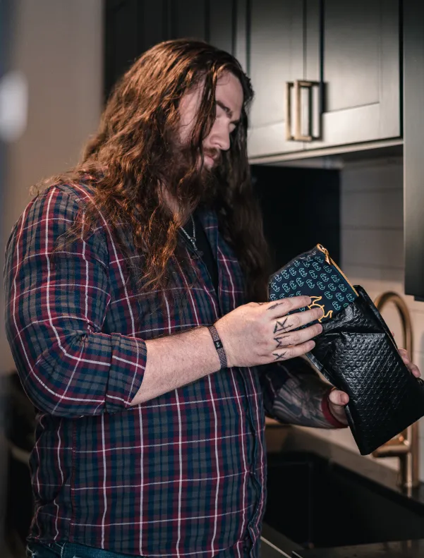 Man holding Viking Man packaging for Finasteride treatment.
